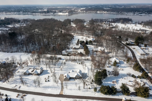 snowy aerial view featuring a water view