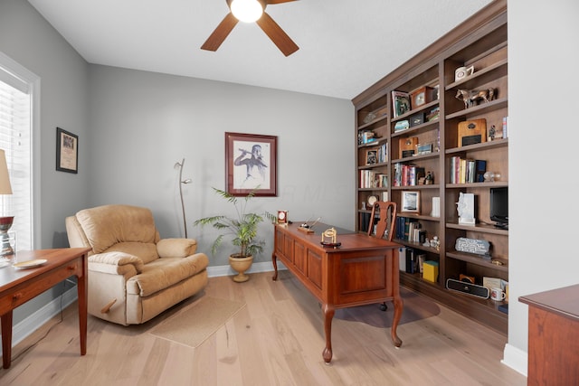 home office with ceiling fan and light hardwood / wood-style flooring