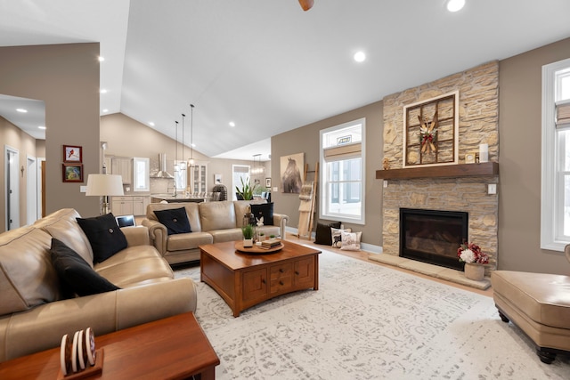 living room featuring lofted ceiling and a fireplace