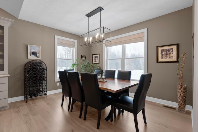 dining room featuring a notable chandelier and light hardwood / wood-style floors