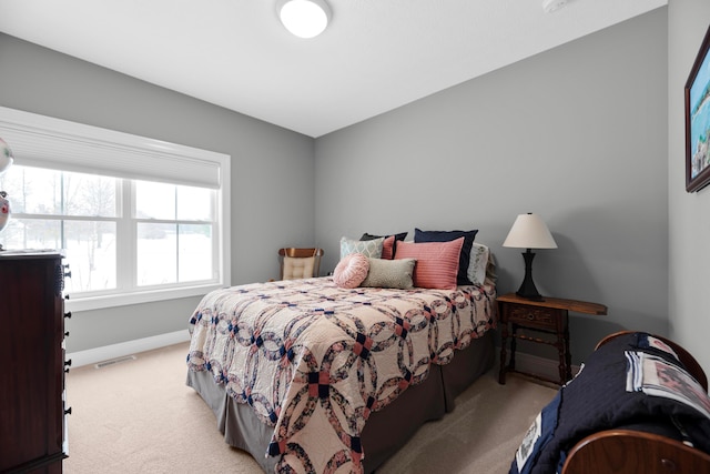 bedroom featuring light carpet