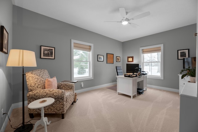 carpeted home office featuring ceiling fan