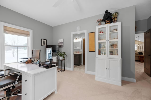 carpeted office with ceiling fan and sink