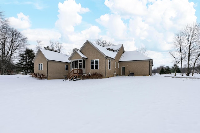 view of snow covered rear of property