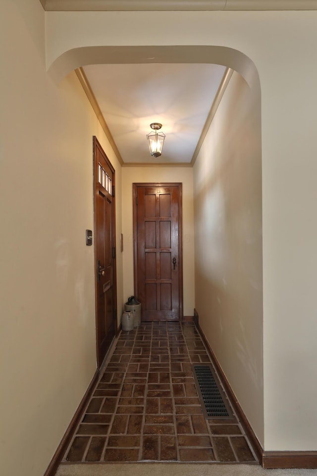 doorway to outside featuring crown molding