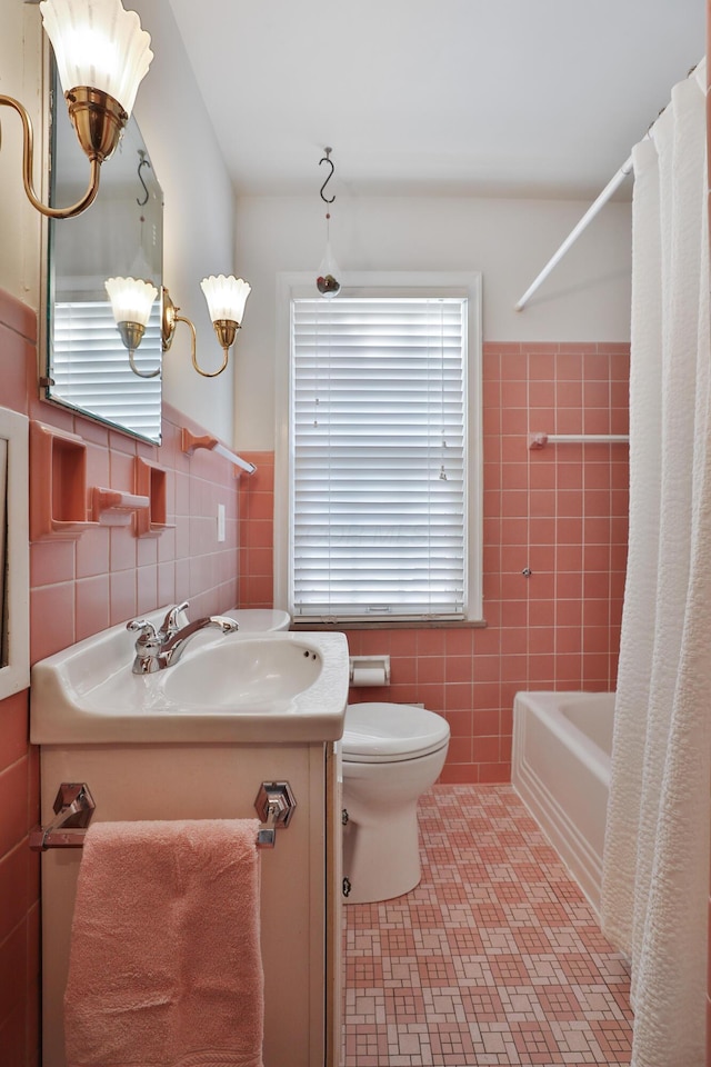 full bathroom with vanity, tile walls, tile patterned floors, and toilet