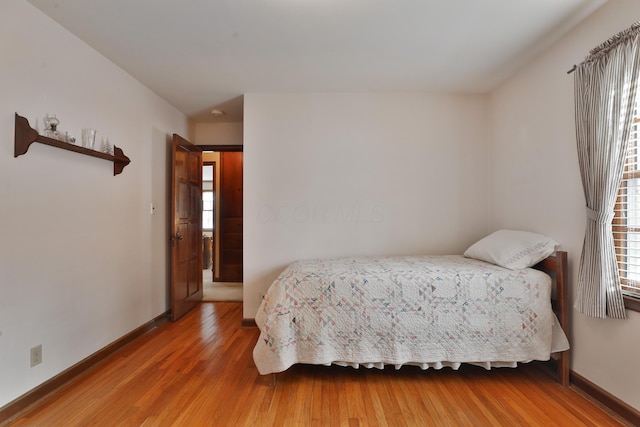 bedroom with wood-type flooring