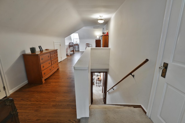 hallway featuring lofted ceiling and dark hardwood / wood-style flooring