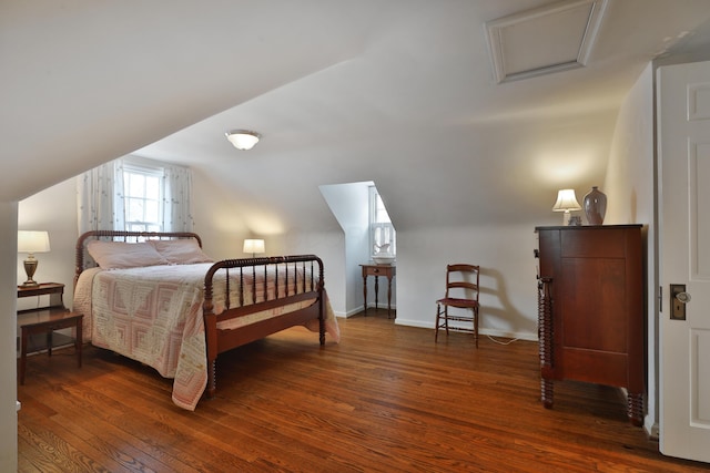 bedroom featuring vaulted ceiling and dark wood-type flooring