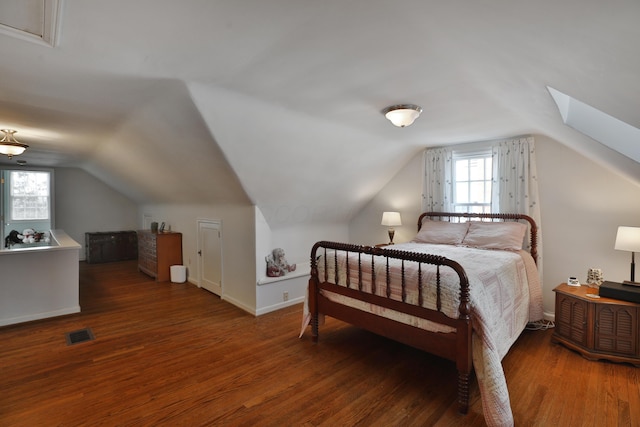 bedroom featuring vaulted ceiling and dark hardwood / wood-style floors