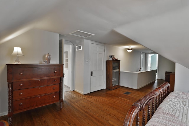 bedroom featuring dark wood-type flooring and lofted ceiling