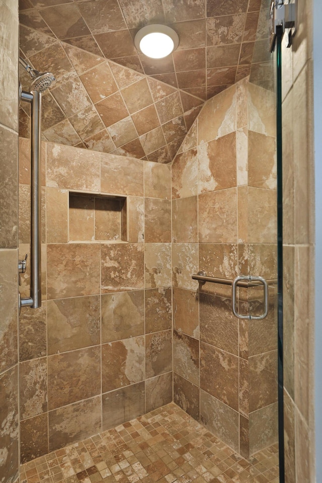 bathroom with a shower with door