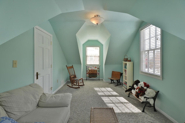 interior space with plenty of natural light, light carpet, and lofted ceiling