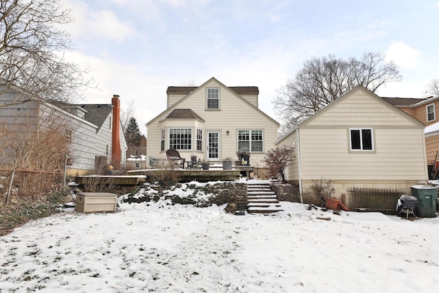 snow covered property with a deck