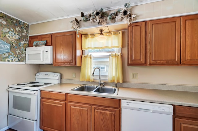 kitchen with sink, white appliances, and ornamental molding