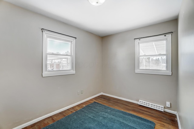 unfurnished room featuring dark hardwood / wood-style floors