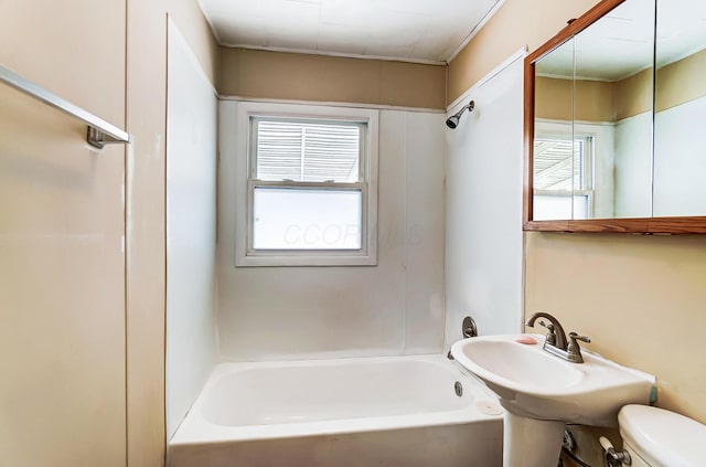 bathroom with plenty of natural light, shower / bathing tub combination, and toilet