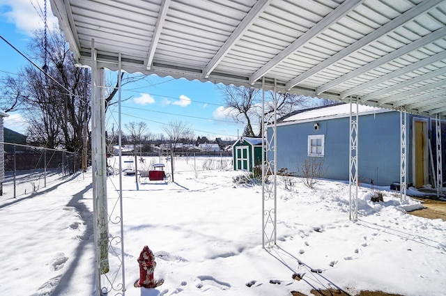 snowy yard with a storage unit