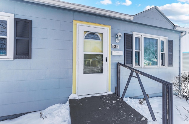 view of snow covered property entrance