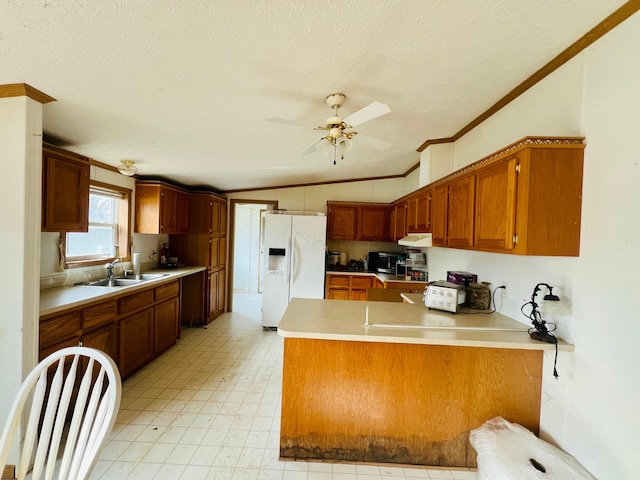 kitchen featuring sink, ceiling fan, ornamental molding, white fridge with ice dispenser, and kitchen peninsula