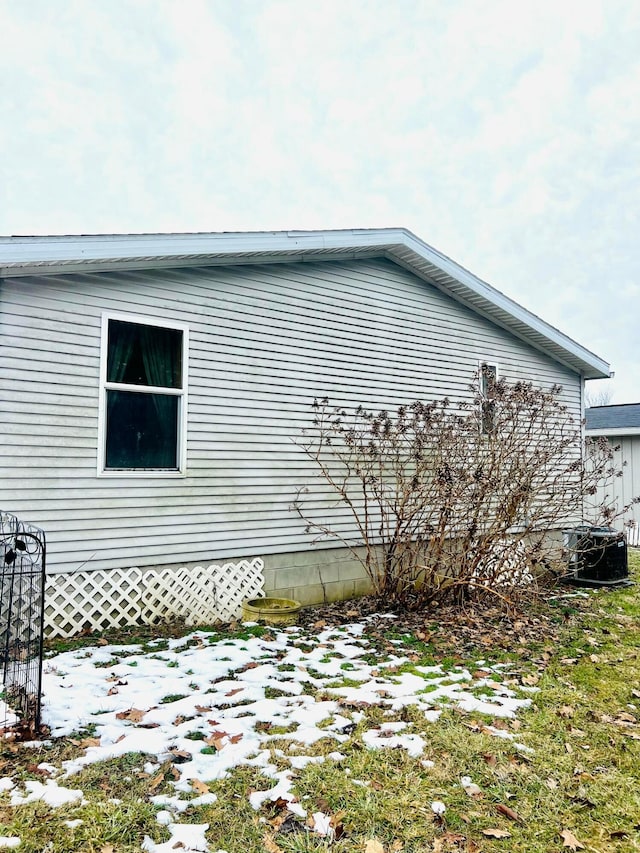 snow covered property with central air condition unit