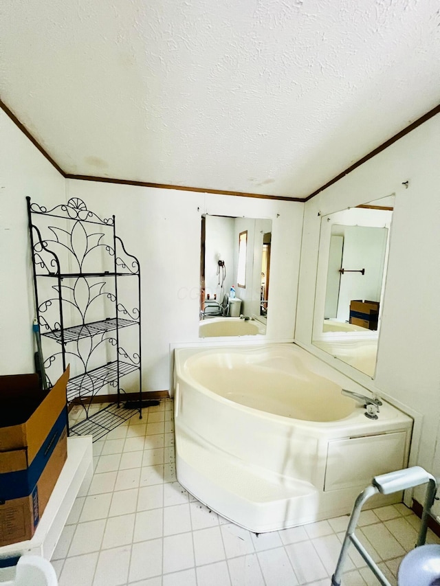 bathroom with a washtub, crown molding, tile patterned floors, and a textured ceiling