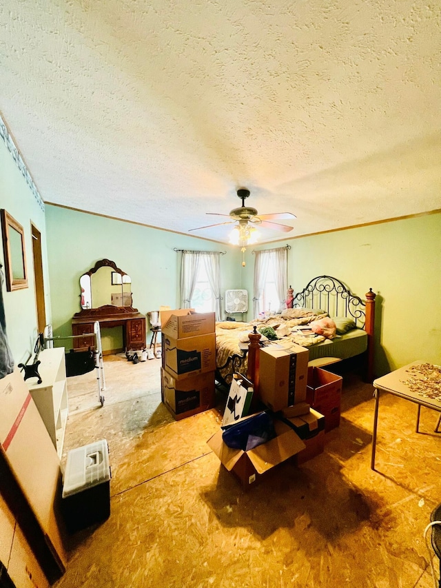 bedroom with ceiling fan, crown molding, and a textured ceiling