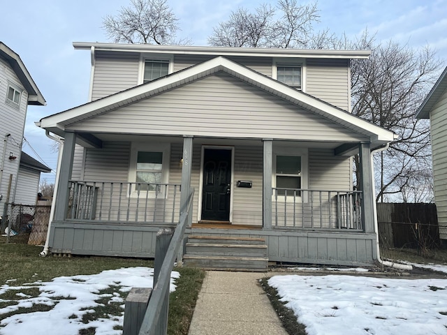 view of front of house with covered porch and fence