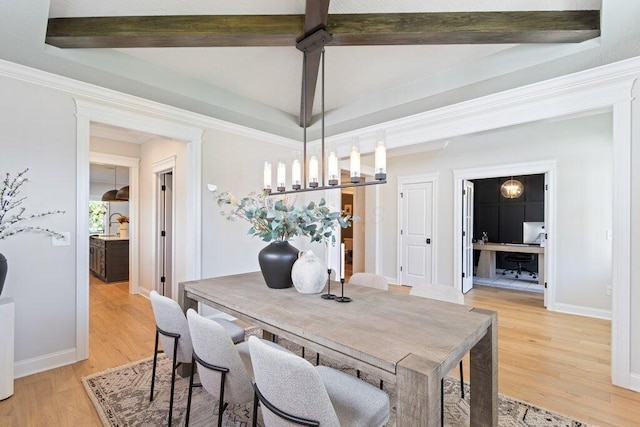 dining space with crown molding, beam ceiling, a chandelier, and light hardwood / wood-style floors