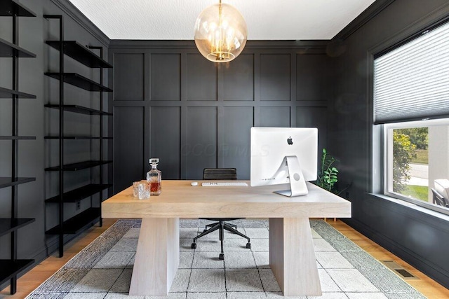 office space with crown molding and light hardwood / wood-style floors