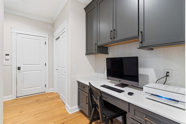 home office featuring crown molding and light wood-type flooring