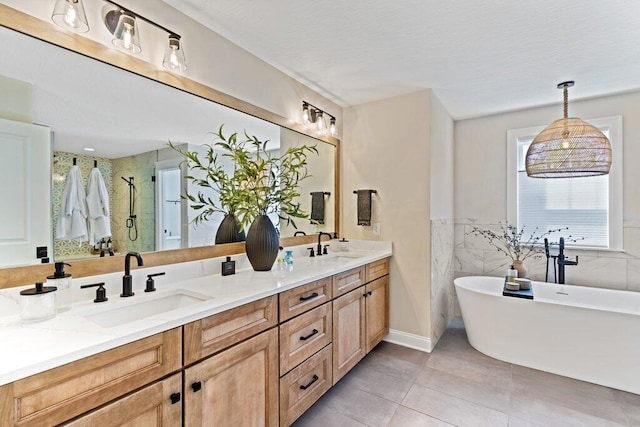 bathroom featuring tile patterned floors, vanity, plus walk in shower, and tile walls