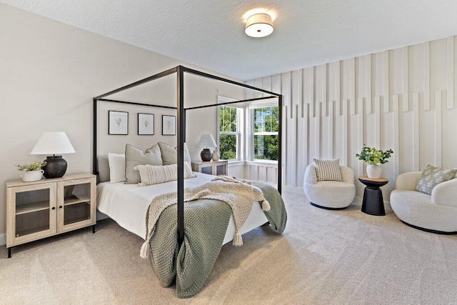 bedroom featuring carpet floors and a textured ceiling