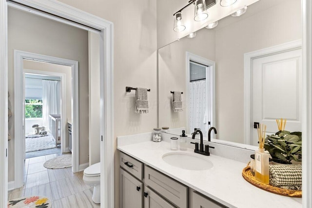 bathroom featuring vanity and toilet