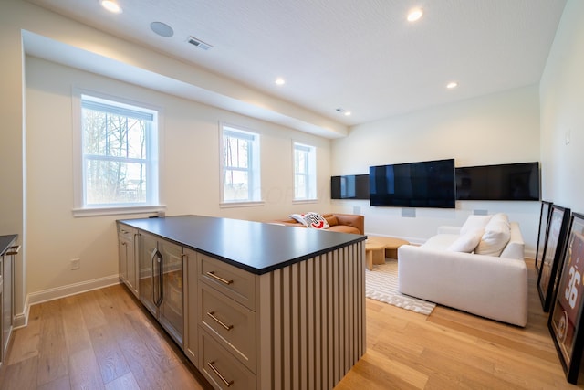 kitchen with wine cooler and light hardwood / wood-style floors