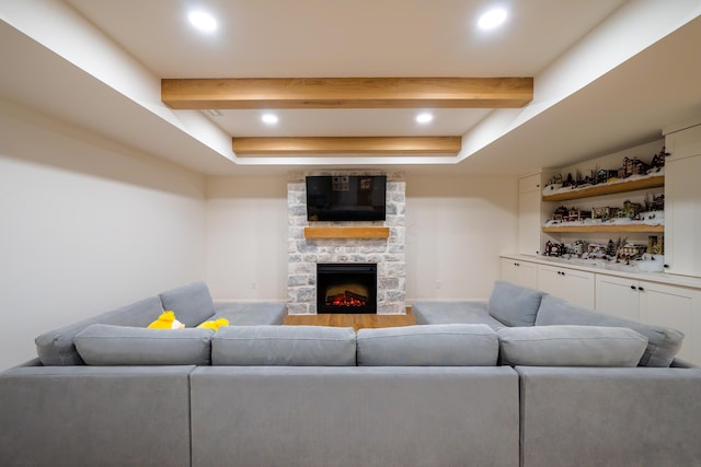 living room featuring beamed ceiling, carpet flooring, and a fireplace