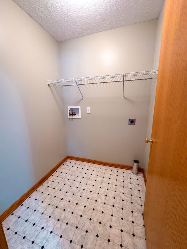 laundry area featuring electric dryer hookup, washer hookup, and a textured ceiling