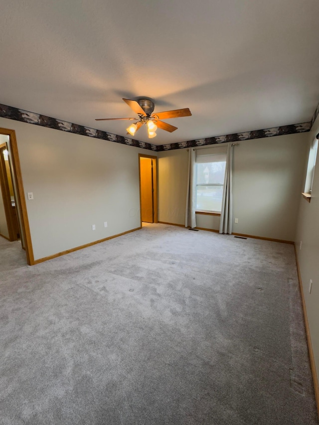 spare room with carpet flooring and ceiling fan