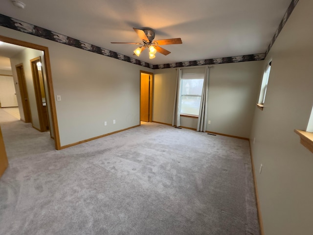 carpeted empty room with ceiling fan