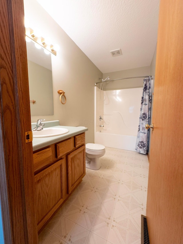 full bathroom featuring toilet, vanity, shower / bathtub combination with curtain, and a textured ceiling