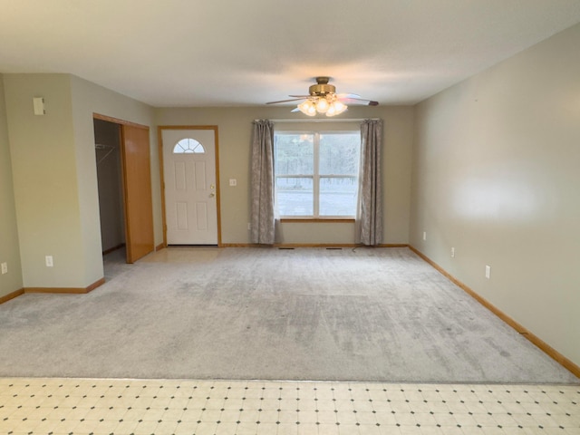 foyer with light colored carpet and ceiling fan