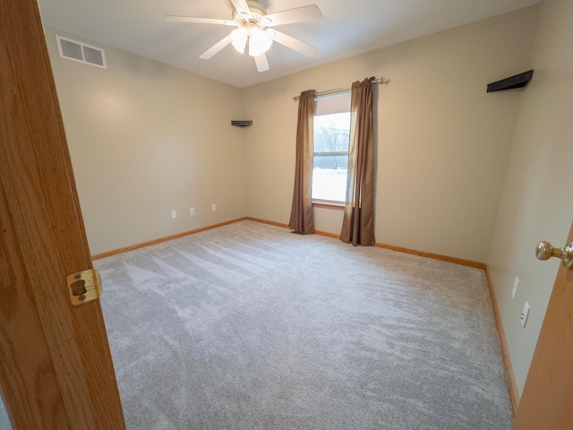 carpeted spare room with ceiling fan