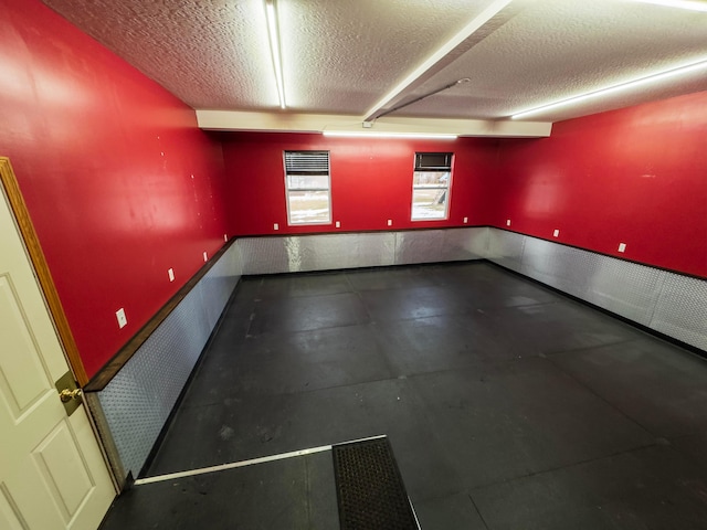 unfurnished room featuring a textured ceiling