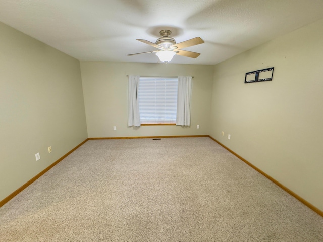 empty room featuring ceiling fan and carpet flooring