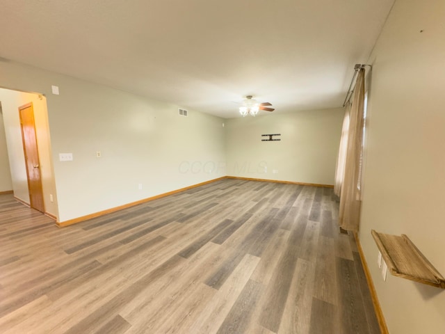 unfurnished room with ceiling fan and hardwood / wood-style floors