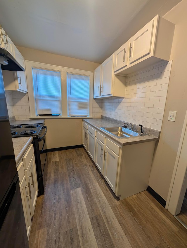 kitchen featuring sink, white cabinetry, backsplash, dark hardwood / wood-style floors, and black range with electric cooktop