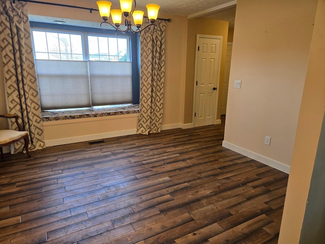 unfurnished room with dark wood-type flooring and a chandelier