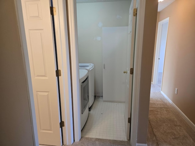 laundry area with light colored carpet and washer and dryer