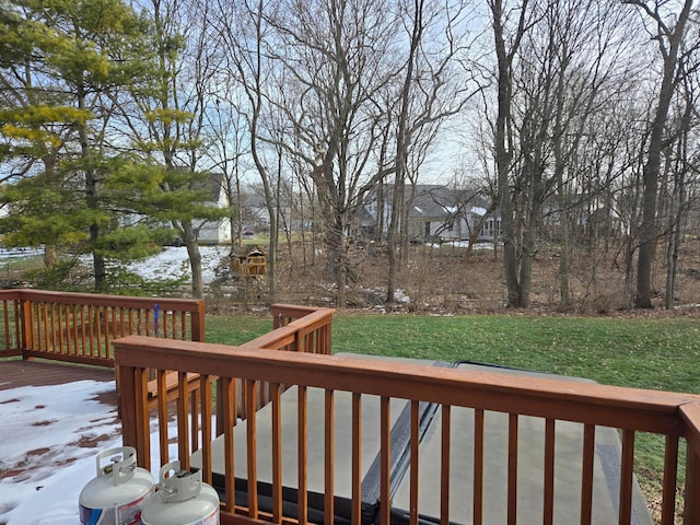 wooden terrace featuring a lawn