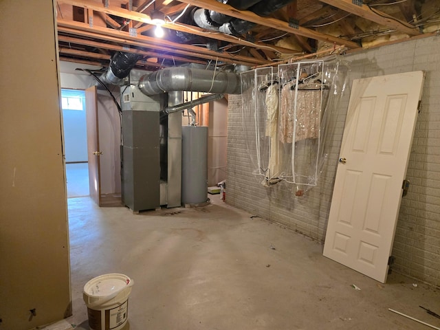 basement featuring water heater and heating unit